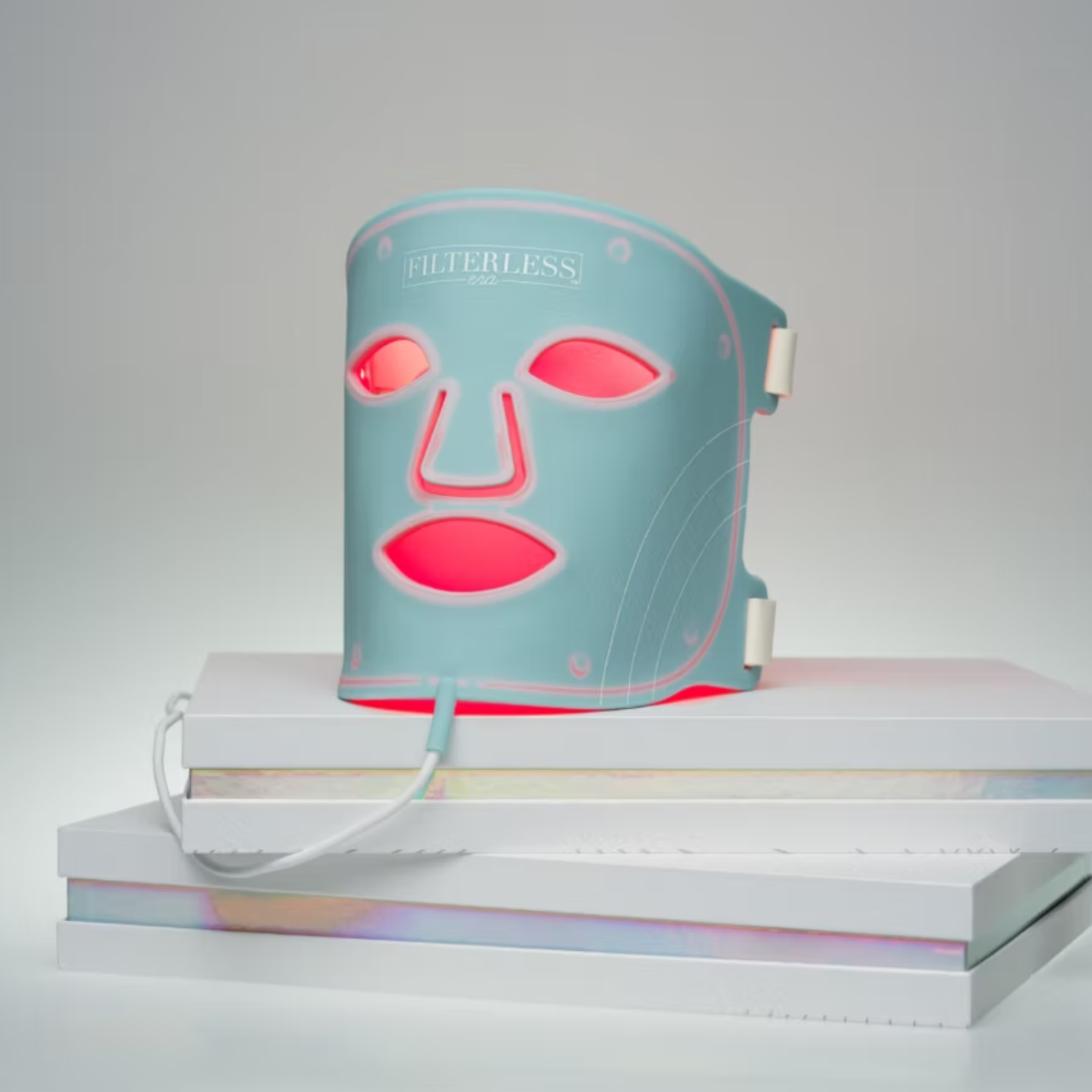A blue skin-rejuvenating LED therapy face mask, a high-end holiday gift idea for employee wellness and self-care.