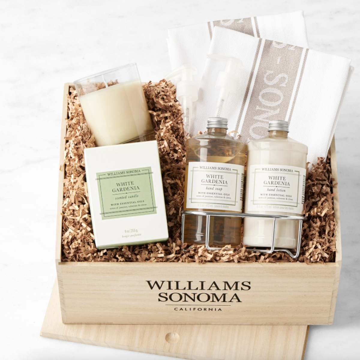 A White Gardenia home fragrance gift crate from Williams Sonoma, featuring a reed diffuser, candle, potpourri, and room spray.