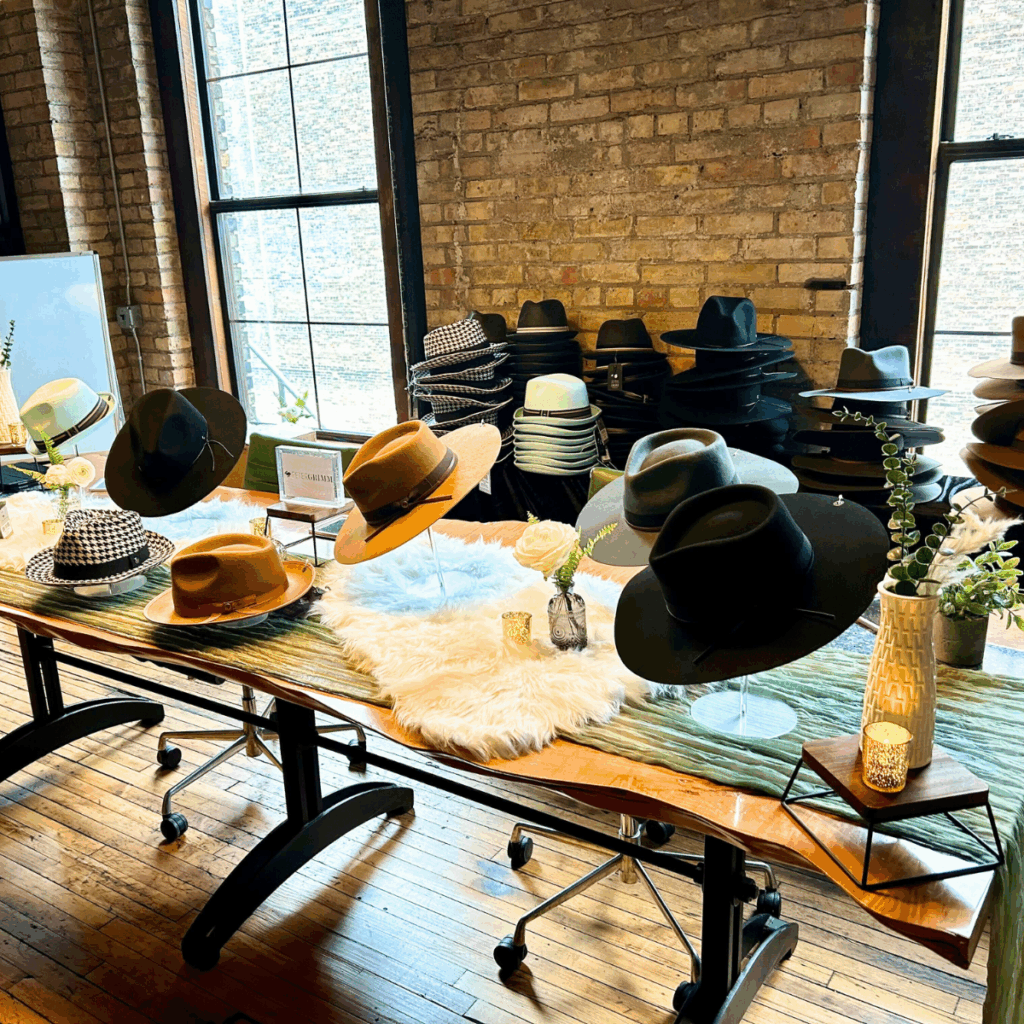 Onsite corporate gift event showcasing a curated hat bar with boutique-style displays and personalized onsite gifting ideas.